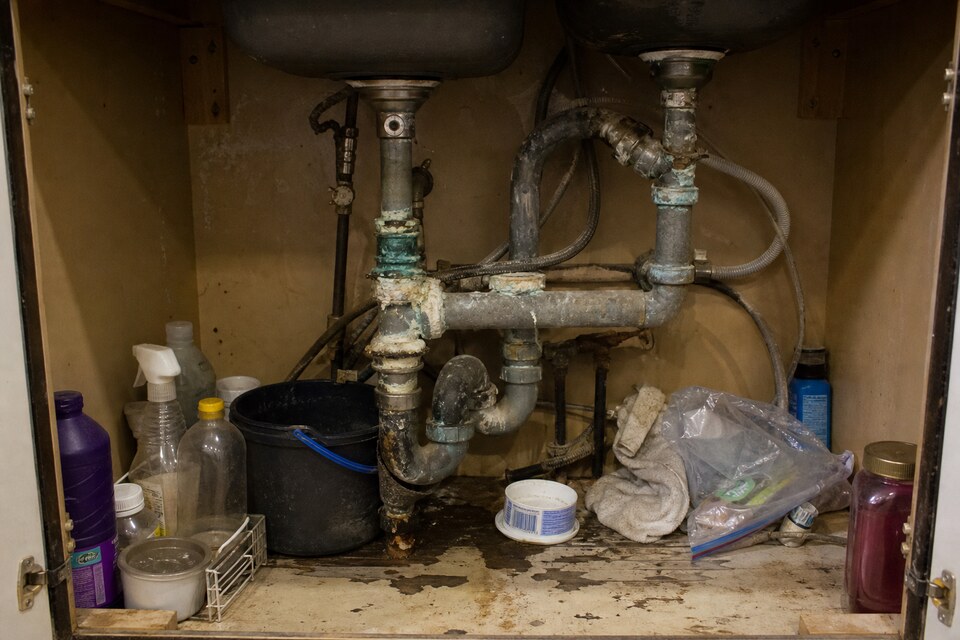 Before — corroded galvanized pipes